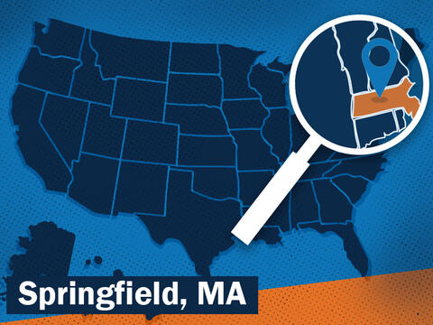 blue map of the U. S. with magnifying glass highlighting massachusetts with a location marker over the Springfield area